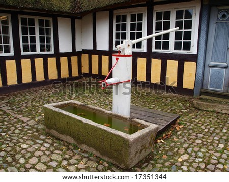 Old vintage well water pump in village Denmark
