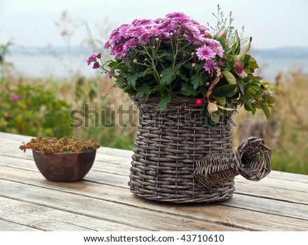 Beautiful still life basket of flowers on a wooden table