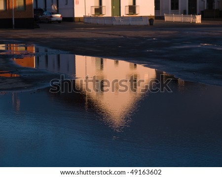 Reflection of a beautiful house in a water pond city abstract