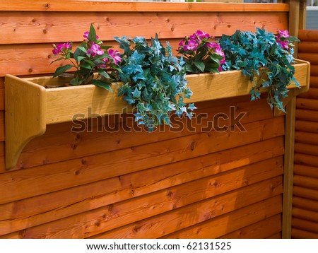 Beautiful classical design planter flowerpot on a garden wooden fence