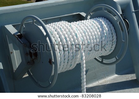 Nautical boat rope rolled on a metal drum winch on deck