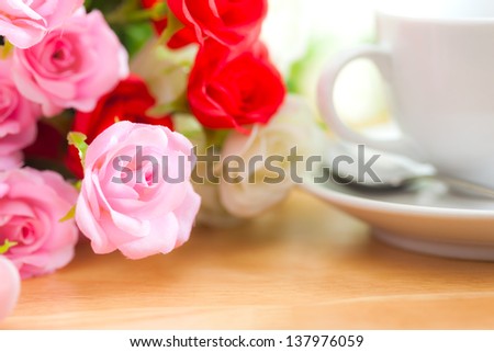 artificial roses on wooden desk
