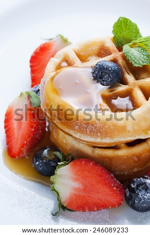 waffles with strawberry and blueberry and caramel sauce