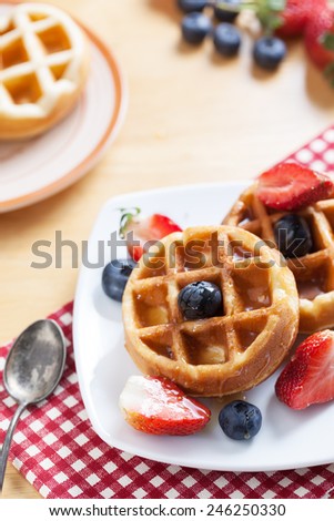 waffles with strawberry ,blueberry and caramel sauce