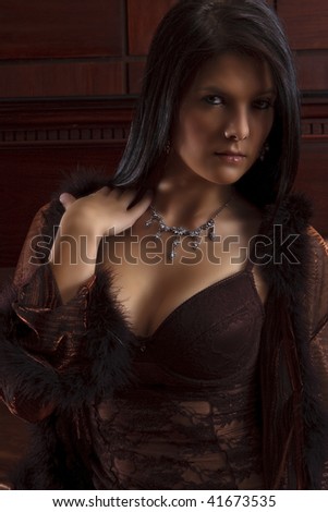 Portrait of young beautiful black haired female in lingerie