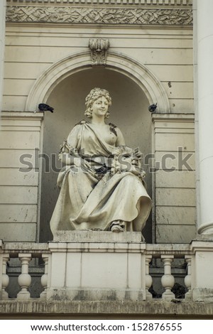Statue of a woman with theatrical mask Lviv Ukraine