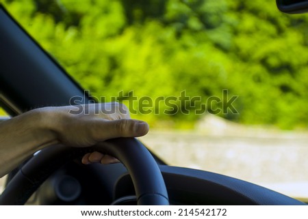 man hands holding black wheel