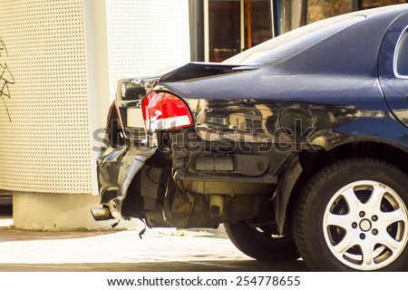 A car has a dented rear bumper after an accident