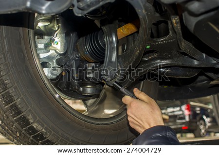 dirty car mechanic hands examining car automobile at repair service station