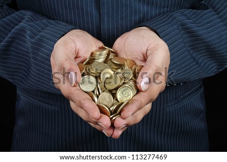 Indian Businessman\'s Hands Holding Gold Coins