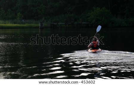 Kayak.. a man in a kayak from behind.