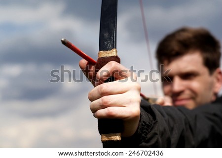 A man shoots an arrow at a target on the nature