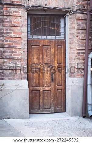 Old wooden door - entrance to the brick house