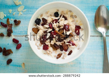 Healthy Breakfast - Oatmeal with dried fruit at blue table