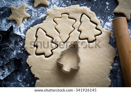 Baking Christmas cookies -  dough on the table, cookie cutters and cookies.