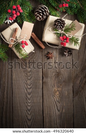 Packing Christmas gifts. Christmas gift boxes and decorations on wooden table. Top view with copy space