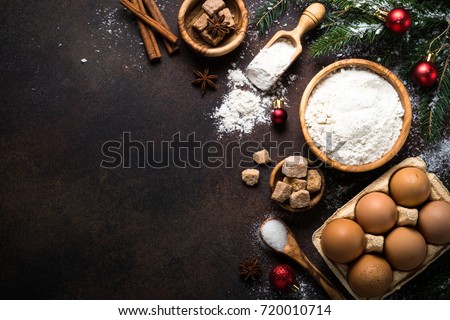Christmas Baking background. Ingredients for cooking christmas baking on dark stone or metal background. Top view with copy space.