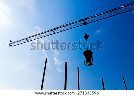Silhouette of industrial construction crane on a beautiful sky background