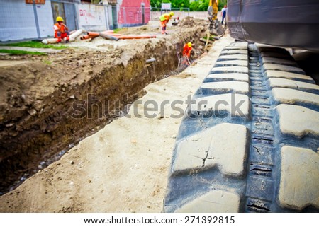 Excavator crawler belt close up in construction site.