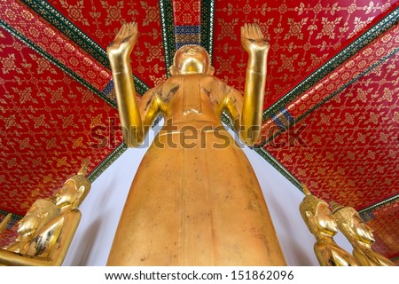 Gilded Buddha statue view from above with diminishing perspective in Wat Pho temple in Bangkok, Thailand