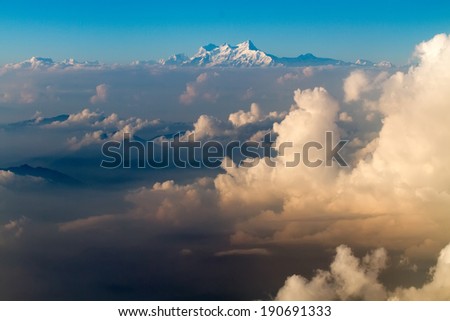 The Everest mount aerial view from plane over cloud sea before landing in Kathmandu in Nepal
