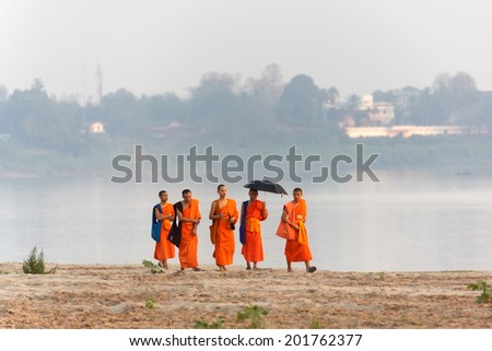 VIENTIANE,LAOS, February 14 : Unidentified Buddhist monks walking on the Mekong river\'s bank in Vientiane,Laos, on February 14, 2012