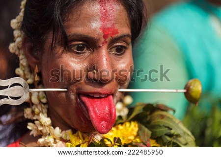 BATU CAVES, MALAYSIA, FEBRUARY 07, 2012: Woman Hindu devotee with pierced tongue during annual Thaipusam religious festival in Batu Caves, near Kuala Lumpur, Malaysia.