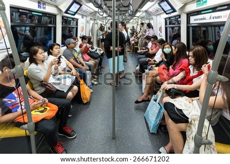 BANGKOK, THAILAND, JANUARY 12, 2015: Passengers inside in the Bangkok Mass Transit System (BTS) skytrain in Thailand