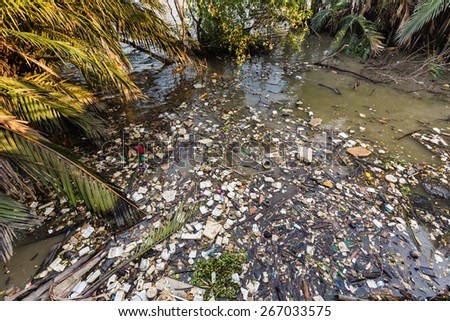 Water rubbish pollution with plastic and other floating stuffs in the chao phraya river in Bangkok, Thailand