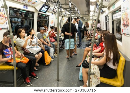 BANGKOK, THAILAND, JANUARY 12, 2015: Passengers inside in the Bangkok Mass Transit System (BTS) public train in Thailand