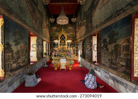 BANGKOK, THAILAND, JANUARY 14, 2015: Two Thai women are praying in the Wat pathum wanaram Buddhist temple in Bangkok, Thailand.