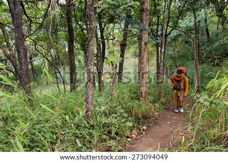 CHIANG DAO, THAILAND, JANUARY 05, 2015: A Buddhist monk is trekking to reach the top of the Chiang Dao mount for a new year meditation in Thailand.