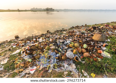 Rubbish pollution with plastic and other packaging stuffs on the bank of the Taungthaman lake near U Bein bridge in Myanmar (Burma)