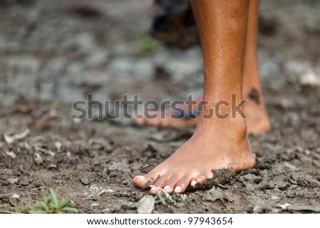 wild woman foot on mud
