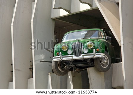 beautiful green collection car in concrete wall frame