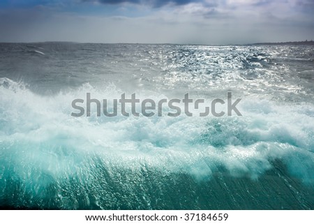 ocean wave, view from boat window with drops on glass
