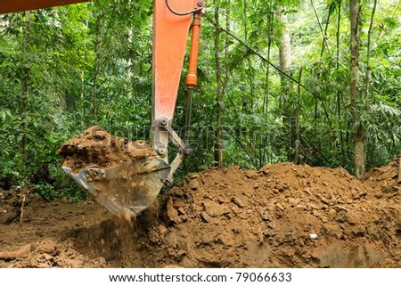 earth mover in tropical rainforest, forest destruction