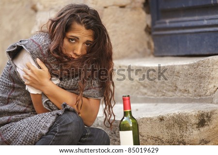 poor homeless drunk woman in cold weather
