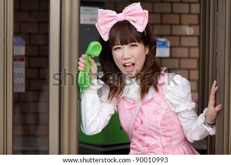 japanese girl in sweet lolita cosplay style in public phone, Tokyo
