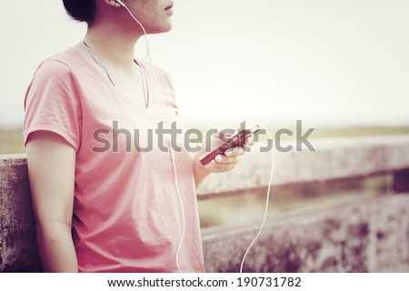 Listening Music - Young girl listening to music with retro filter effect