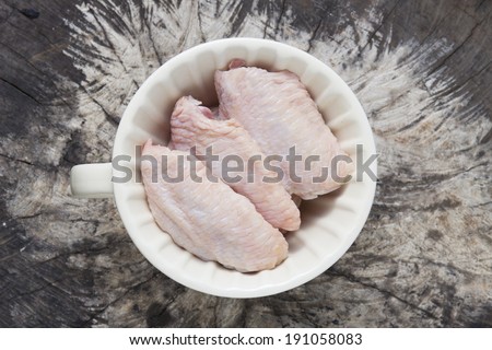 Raw chicken meat - Top view of raw meat inside cup on natural background