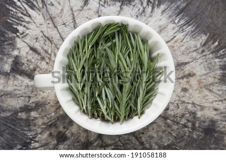 Rosemary herb - Top view of rosemary herb inside cup on natural background