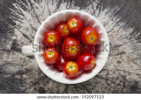 Cherry tomatoes - Top view of cherry tomatoes inside cup on natural background