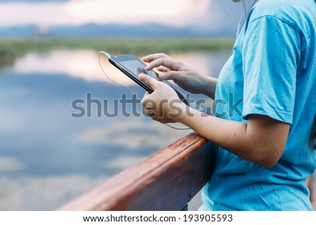 Lifestyle Tablet Tech User Enjoying Vacation with retro filtered color effect