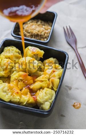 Chinese steamed dumplings eating with fried garlic and chinese vinegar.