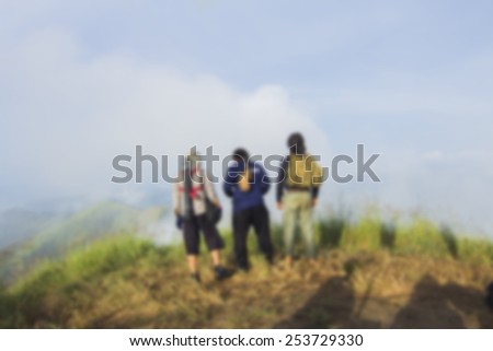 Blurred travel backgrounds of three people on the mountain.