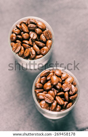 Coffee beans for espresso shot in a cafe or coffee shop. Photo in vintage color tone style.