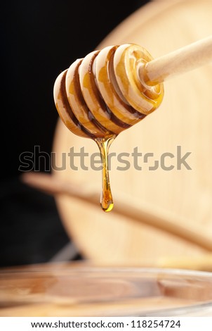 Sticky honey clinging onto a wooden stick