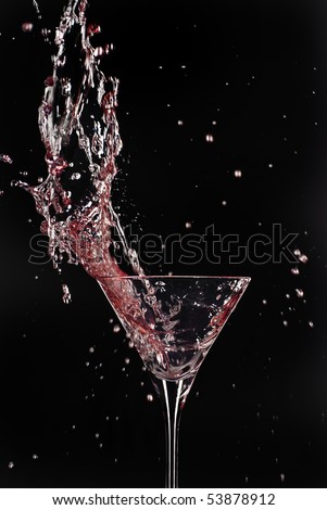 Cocktail big splash with red martini with black background