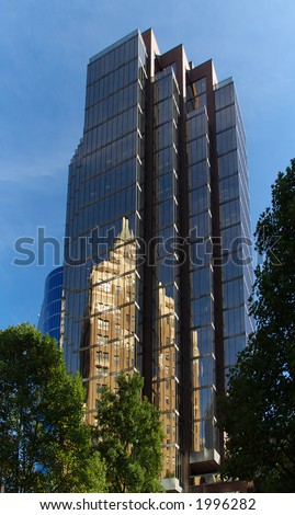 Office tower in Vancouver, British Columbia reflecting the marine building in the windows